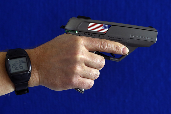 An Armatix employee holds a smart gun manufactured by the company. The gun is implanted with an electronic chip that allows it to be fired only if the shooter is wearing a watch that communicates with it through a radio signal. Credit: Michael Dalder/Reuters
