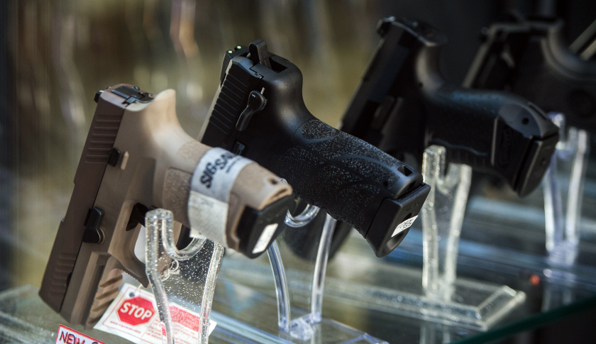 Sig Sauer Inc. handguns are displayed in a shop window in Lugano, Switzerland, on Thursday Nov. 19, 2015. Photographer: Akos Stiller/Bloomberg via Getty Images